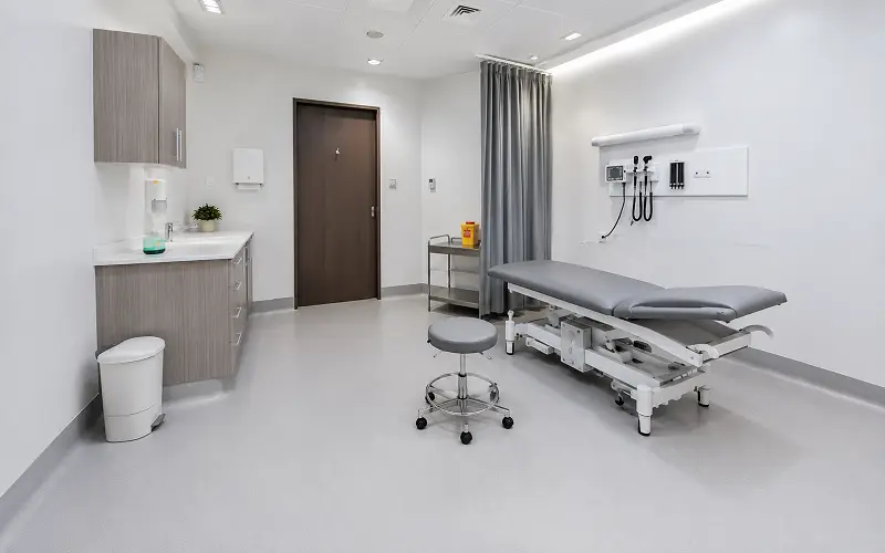 Heat-welded vinyl sheet flooring in a Dubai Healthcare City clinic with antimicrobial wear layer