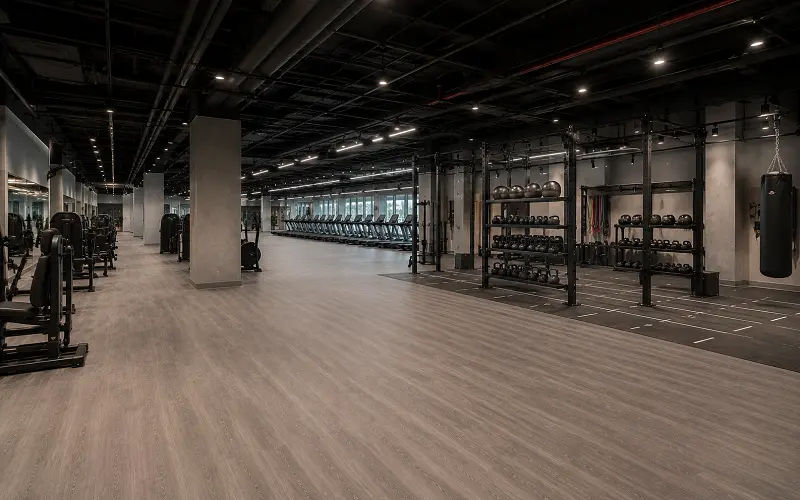 Commercial gym chain interior with Class 34 SPC vinyl flooring across cardio and functional zones in Dubai