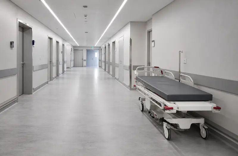 Heavy-duty heterogeneous vinyl sheet flooring in a UAE hospital corridor with trolley traffic