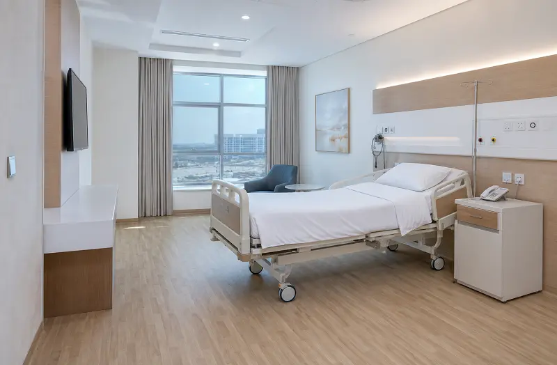 Heat-welded heterogeneous vinyl sheet flooring in a Dubai hospital patient ward with coved skirting