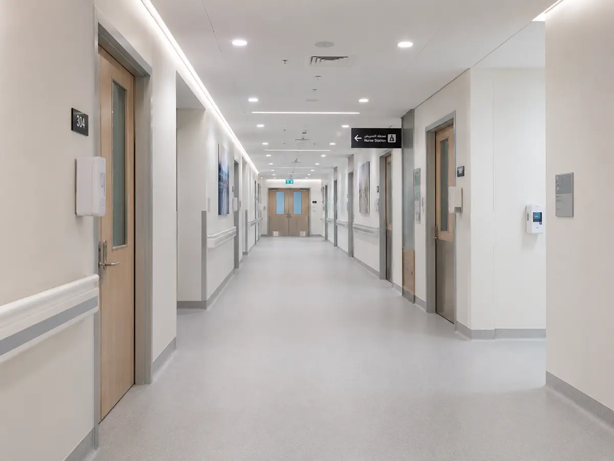 Heat-welded vinyl sheet flooring with coved skirting installed in a Dubai hospital corridor