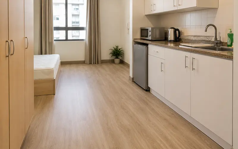 Vinyl sheet flooring in an Abu Dhabi studio apartment kitchen with seamless single-roll install