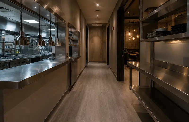 SPC vinyl flooring in a Dubai restaurant service walkway and expediter zone between kitchen and dining