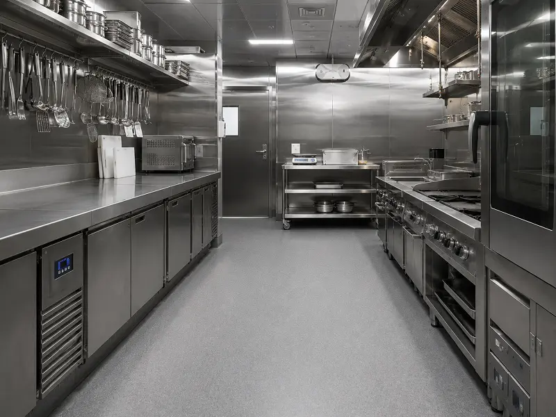 Vinyl sheet flooring with coved skirting in a Dubai commercial kitchen back-of-house